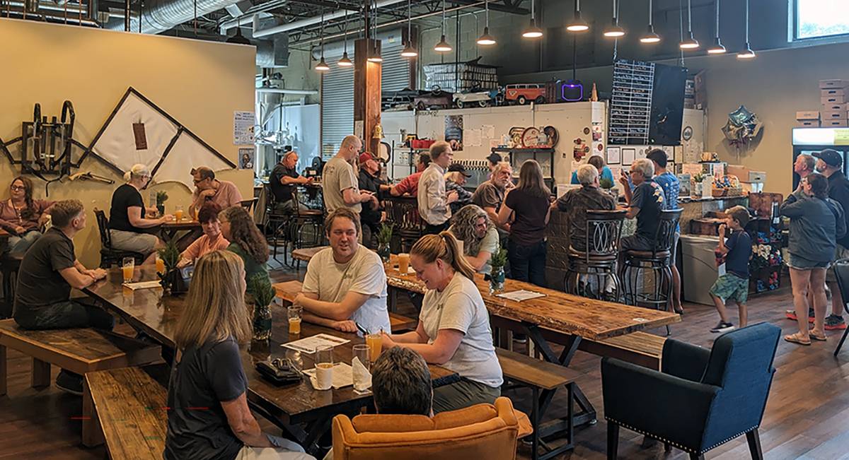 A crowd gathers inside Dirigible Brewing Company’s taproom on July 24, 2024, to celebrate the second annual release of “All Spruced Up,” a collaborative American pale ale brewed with sustainably harvested red spruce tips from NEFF’s Lincoln Davis-Cabot-Morse Memorial Forest in Sharon and Temple, New Hampshire.